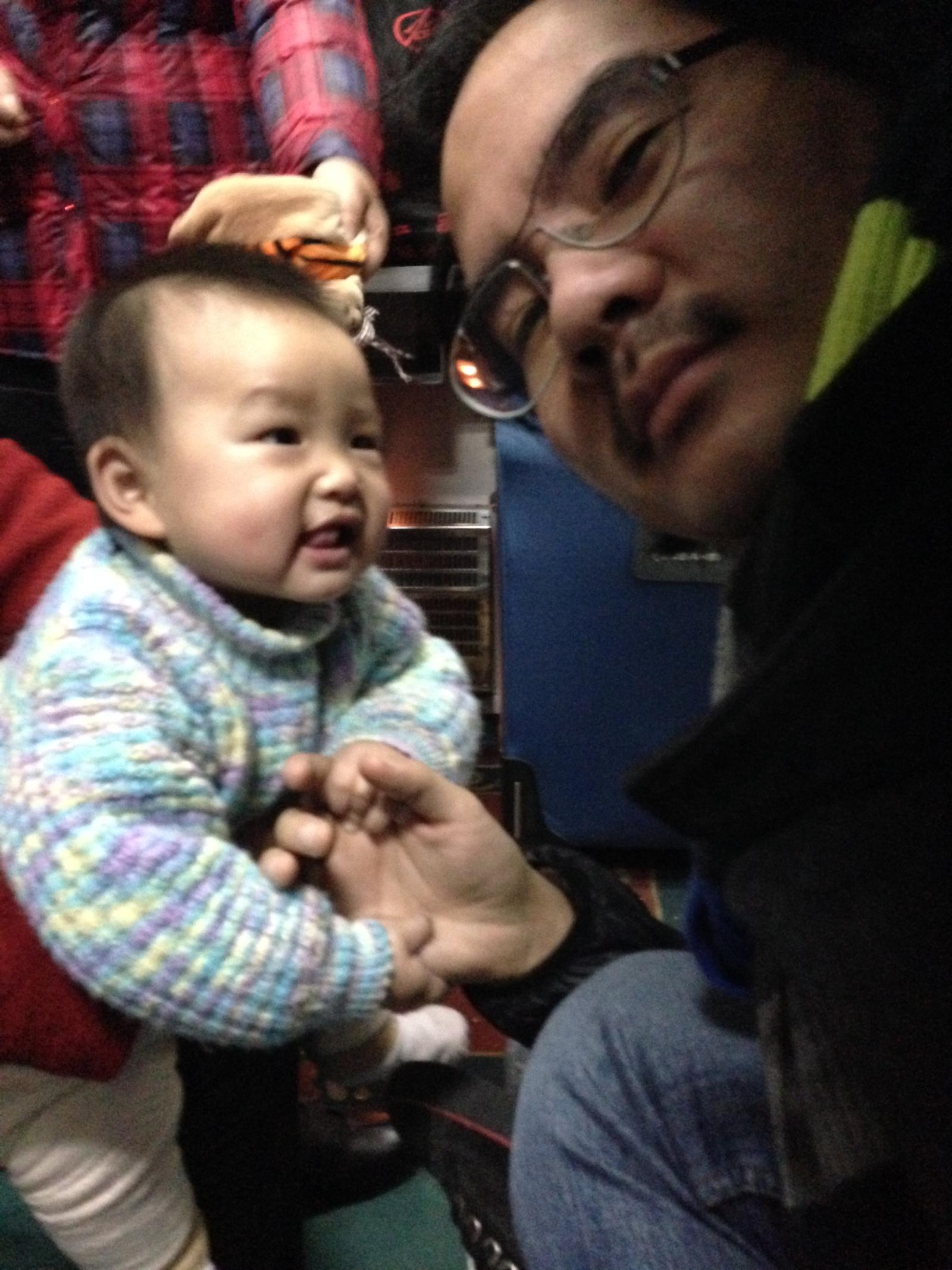 On the train, with a new young friend, from Shanghai to Shenzhen in January 2015. 